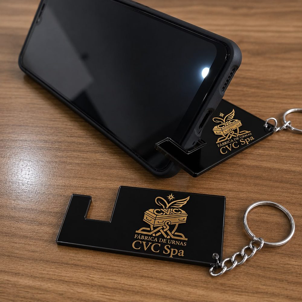 Llaveros corporativos con soporte de teléfono y el logo dorado de CVC Spa